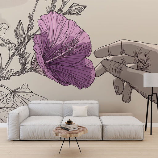 Une pièce moderne avec un papier peint illustrant une main délicate touchant une grande fleur rose sur fond beige, créant une ambiance artistique et apaisante.