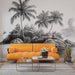 Un salon moderne avec un papier peint représentant des palmiers et des rochers en noir et blanc, créant une ambiance tropicale et apaisante.