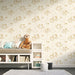 Une chambre enfantine avec un papier peint illustrant des motifs dorés de petits animaux et de plantes sur fond clair, créant une ambiance douce et ludique.