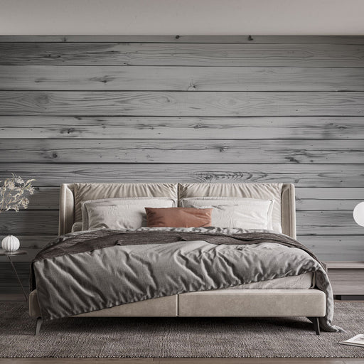 Une chambre moderne avec un papier peint imitation bois gris, créant une ambiance chaleureuse et naturelle, idéale pour la détente.