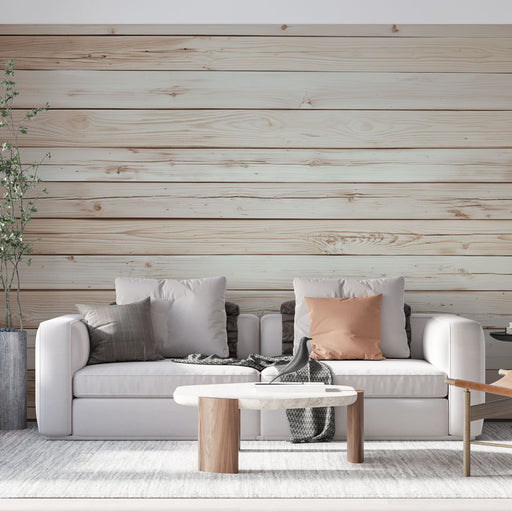Un salon moderne avec un papier peint imitant des planches de bois claires, créant une ambiance chaleureuse et naturelle.
