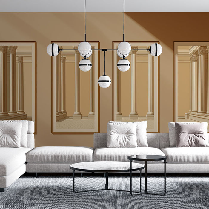 Un salon moderne avec un papier peint représentant des colonnes classiques en perspective sur un fond beige, créant une ambiance élégante et sophistiquée.