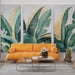 Un salon moderne avec un papier peint tropical représentant de grandes feuilles vertes et dorées sur fond clair, créant une ambiance fraîche et accueillante.