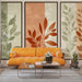 Un salon moderne avec un papier peint aux motifs de feuilles stylisées dans des teintes douces de vert et d'orange, créant une ambiance chaleureuse et naturelle.