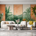 Un salon moderne avec un papier peint tropical représentant de grandes feuilles vertes et des montagnes sur un fond dégradé orange, créant une atmosphère chaleureuse et accueillante.