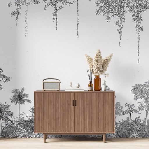 Une salle de séjour moderne avec un papier peint illustratif noir et blanc représentant une végétation luxuriante, créant une atmosphère artistique et apaisante.