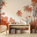 Une pièce lumineuse avec un papier peint tropical aux motifs de palmiers et de fleurs dans des teintes orangées, créant une atmosphère chaleureuse et accueillante.