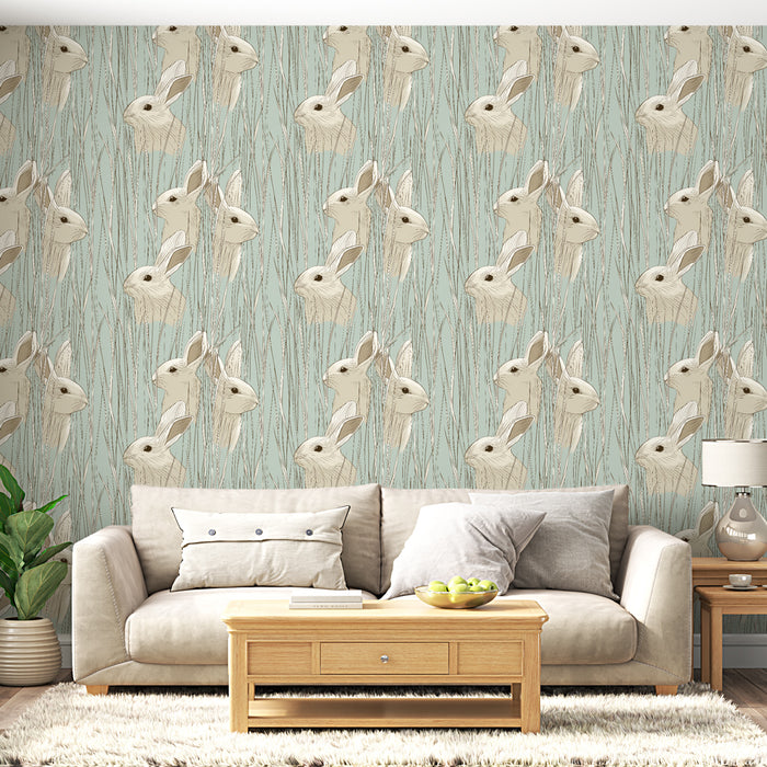 Un salon moderne avec un papier peint illustrant des têtes de lapins sur fond bleu clair, créant une atmosphère ludique et chaleureuse.