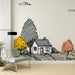 Une pièce moderne avec un papier peint illustratif représentant une maison entourée d'arbres aux couleurs vives, créant une ambiance chaleureuse et accueillante.