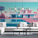 Un salon contemporain avec un papier peint illustrant une villa moderne aux teintes pastel, évoquant une ambiance estivale et relaxante.