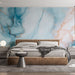 Une chambre moderne avec un papier peint marbré aux nuances de bleu et rose, rehaussé de veines dorées, créant une atmosphère apaisante et élégante.