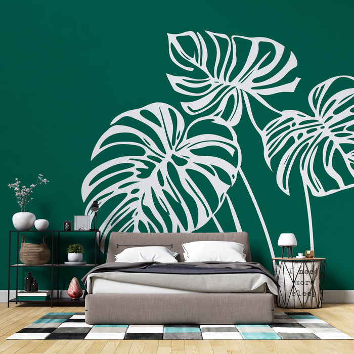 Une chambre moderne avec un papier peint vert émeraude orné de grandes feuilles blanches stylisées, créant une ambiance tropicale et apaisante.