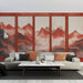Un salon contemporain avec un papier peint représentant des montagnes embrumées dans des teintes rouges et ocres, créant une atmosphère chaleureuse et apaisante.