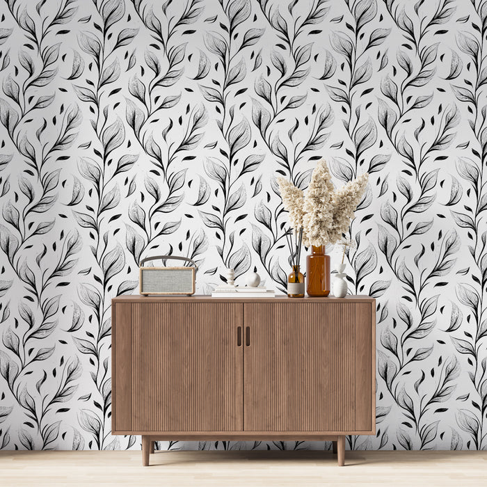 Une salle à manger moderne avec un papier peint noir et blanc aux motifs de feuilles délicates, créant une ambiance élégante et apaisante.