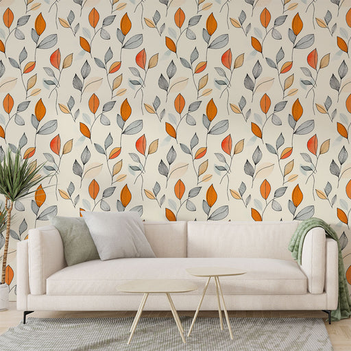 Un salon moderne avec un papier peint floral aux motifs de feuilles stylisées en orange, gris et beige sur fond clair, créant une ambiance chaleureuse et accueillante.