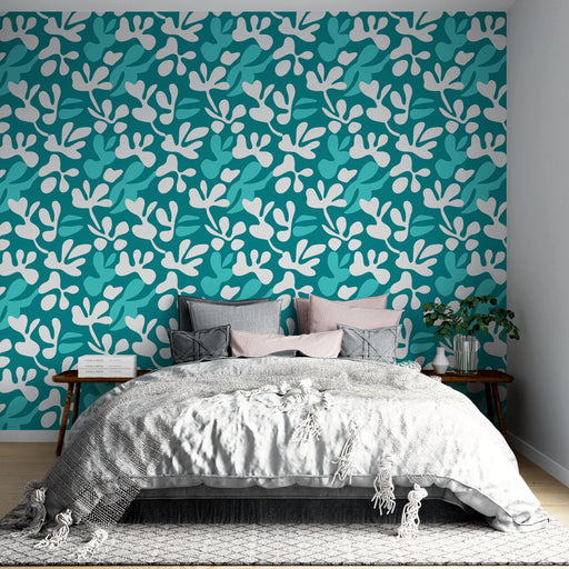 Une chambre moderne avec un papier peint aux motifs floraux stylisés bleu turquoise et blanc, créant une ambiance fraîche et dynamique.