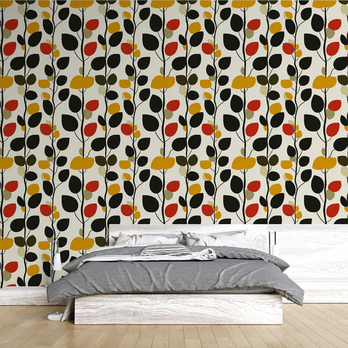 Une chambre moderne avec un papier peint graphique aux motifs de feuilles stylisées en noir, rouge, jaune et vert sur fond clair, créant une ambiance dynamique et chaleureuse.