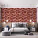 Une chambre moderne avec un papier peint aux motifs de feuilles stylisées dans des teintes rouge et beige, créant une ambiance chaleureuse et accueillante.