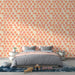 Une chambre moderne avec un papier peint floral aux motifs ronds en dégradés de rose et orange sur fond clair, créant une atmosphère joyeuse et accueillante.