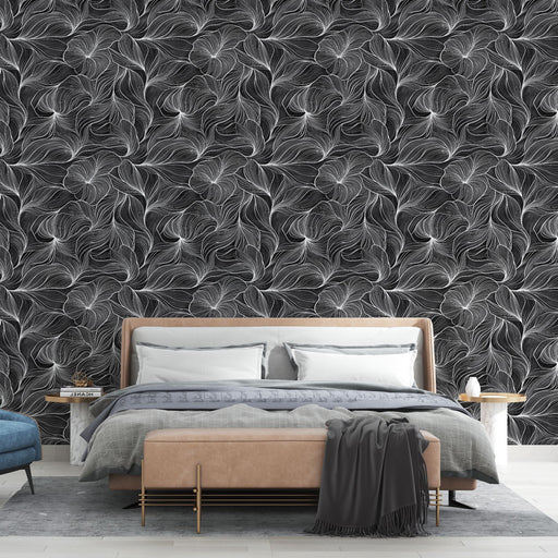 Une chambre moderne avec un papier peint noir et blanc aux motifs de feuilles stylisées, créant une ambiance élégante et sophistiquée.