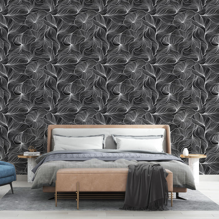 Une chambre moderne avec un papier peint noir et blanc aux motifs de feuilles stylisées, créant une ambiance élégante et sophistiquée.