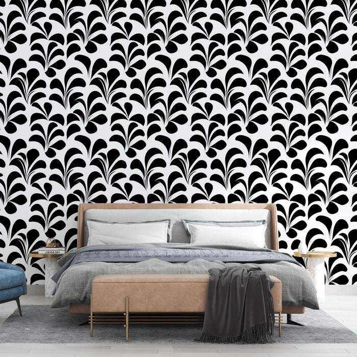 Une chambre moderne avec un papier peint noir et blanc aux motifs stylisés de feuilles, créant une ambiance graphique et élégante.