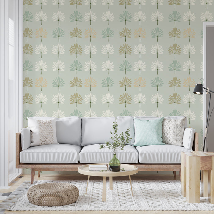 Un salon lumineux avec un papier peint aux motifs de feuilles stylisées dans des teintes douces de vert, beige et blanc, créant une ambiance apaisante et naturelle.
