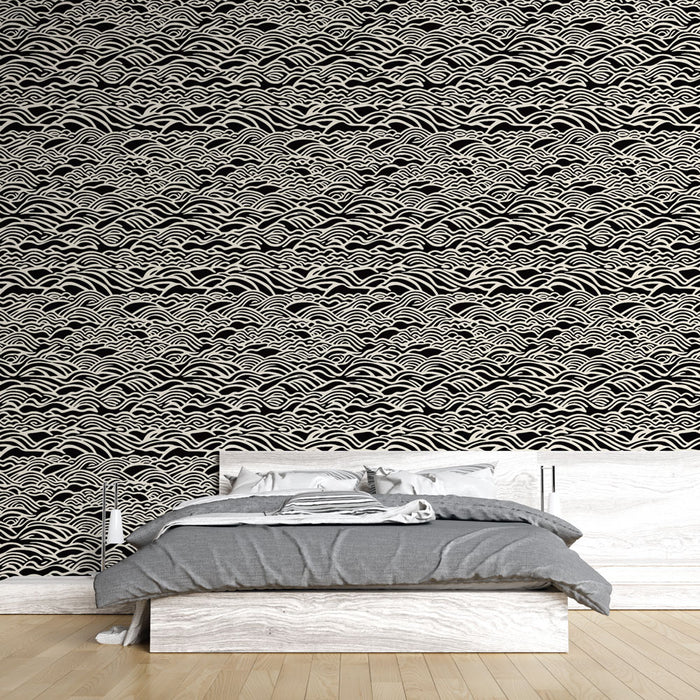 Une chambre moderne avec un papier peint évoquant des vagues stylisées en blanc sur fond noir, créant une atmosphère dynamique et apaisante.