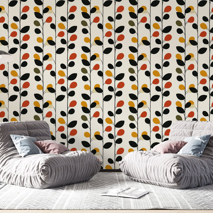Un salon moderne avec un papier peint aux motifs de feuilles stylisées en noir, rouge, jaune et vert sur fond clair, créant une ambiance chaleureuse et dynamique.