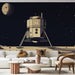 Un salon contemporain avec un papier peint illustrant un atterrisseur lunaire sur fond noir étoilé, créant une atmosphère futuriste et captivante.