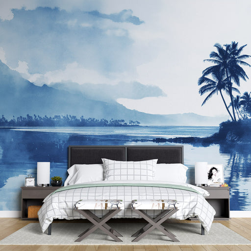 Une chambre moderne avec un papier peint aquarelle bleu représentant un paysage tropical apaisant, évoquant sérénité et évasion.