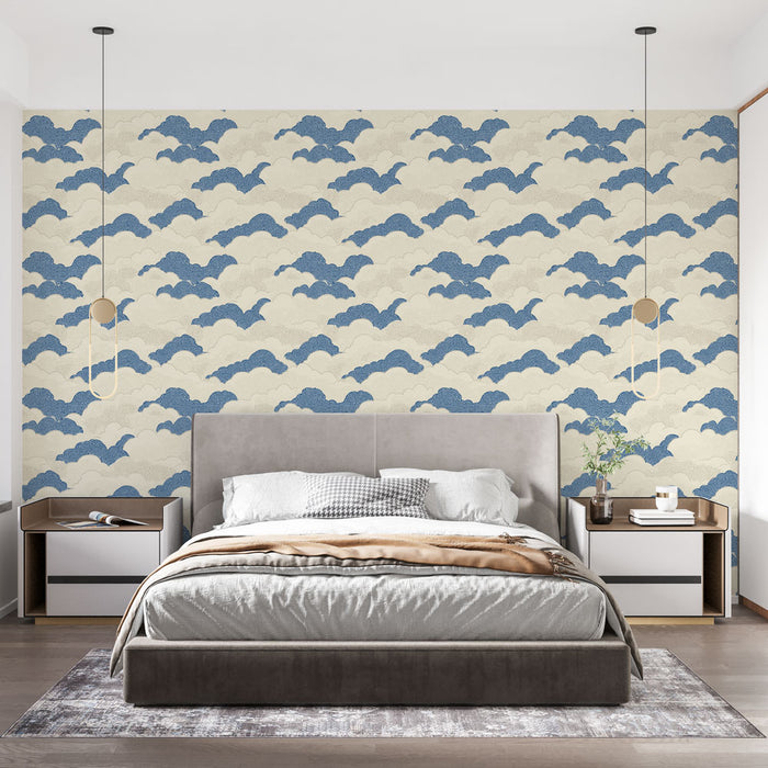 Une chambre moderne avec un papier peint aux motifs de nuages bleus sur fond crème, créant une atmosphère douce et apaisante.