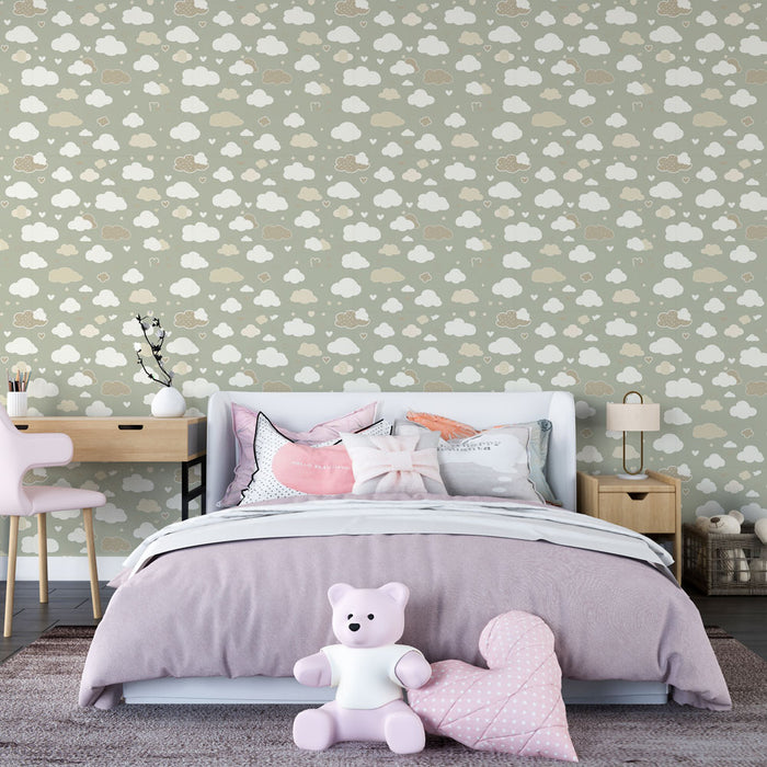 Une chambre douce avec un papier peint représentant des nuages blancs et beiges sur fond vert, créant une atmosphère apaisante et enfantine.