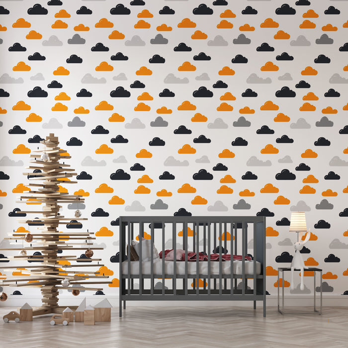 Une chambre d'enfant avec un papier peint ludique représentant des nuages colorés en orange, gris et noir sur fond blanc, créant une atmosphère joyeuse et accueillante.