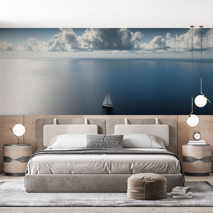 Une chambre moderne avec un papier peint représentant un paysage marin apaisant, où un voilier glisse sur une mer d'un bleu profond sous un ciel nuageux.