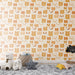 Une chambre d'enfant avec un papier peint ludique aux motifs de têtes d'ours dans des teintes chaudes de beige et caramel, créant une atmosphère douce et réconfortante.