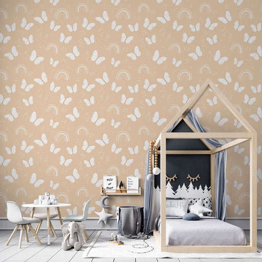 Une chambre d'enfant avec un papier peint beige orné de papillons blancs et d'arcs-en-ciel, créant une atmosphère douce et joyeuse.