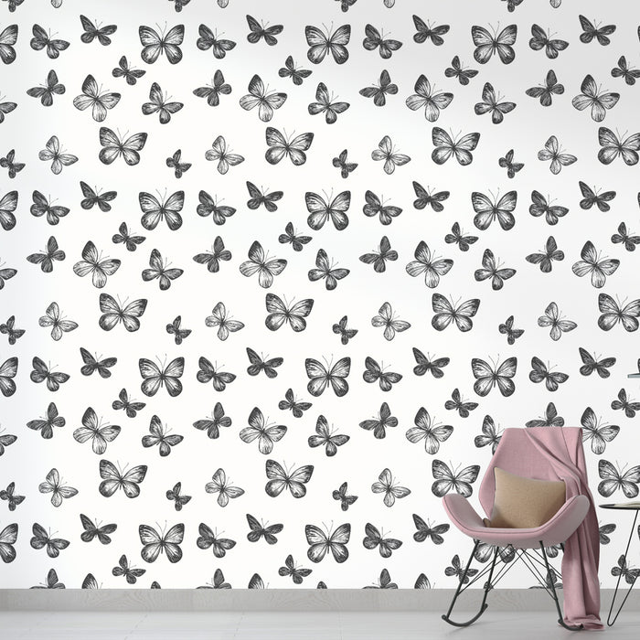 Une chambre moderne avec un papier peint illustrant des papillons en noir et blanc sur fond clair, créant une ambiance légère et délicate.