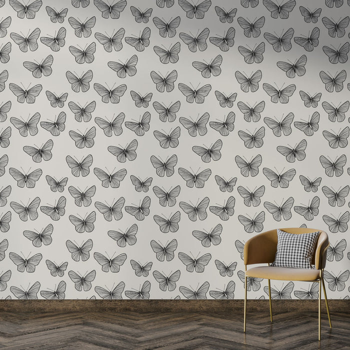 Une pièce moderne avec un papier peint illustrant des papillons en noir sur fond blanc, créant une ambiance légère et artistique.
