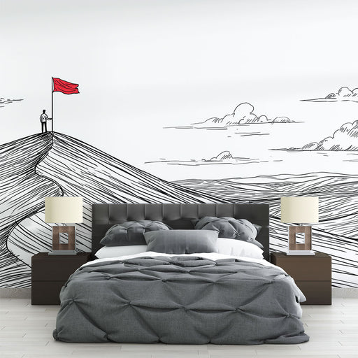 Une chambre moderne avec un papier peint illustratif représentant des collines stylisées en noir et blanc, où un personnage brandit un drapeau rouge, créant une ambiance inspirante et artistique.