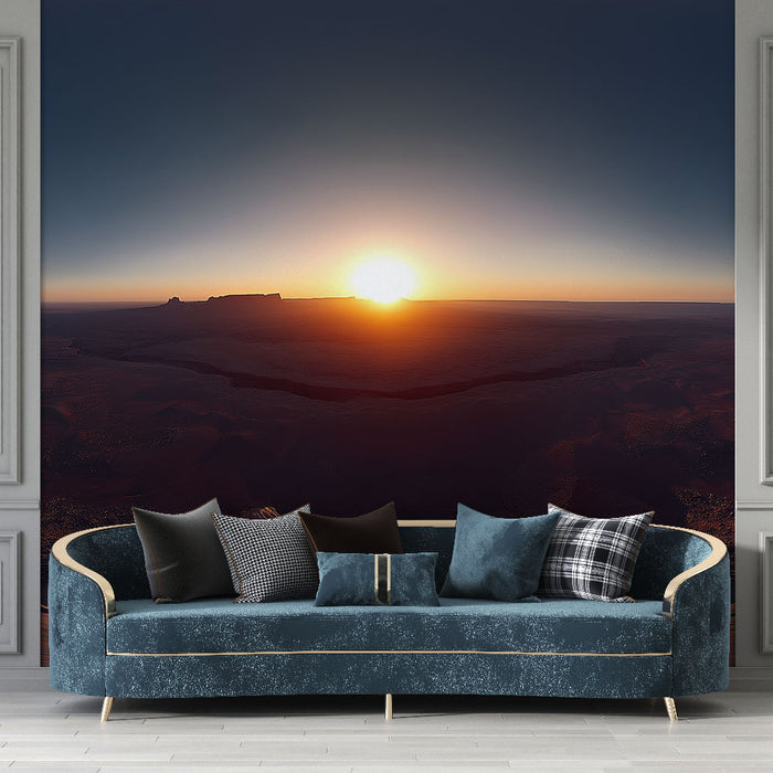 Un salon élégant avec un papier peint représentant un coucher de soleil spectaculaire sur un paysage désertique, créant une atmosphère chaleureuse et apaisante.