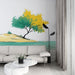 Un salon moderne avec un papier peint illustrant un paysage stylisé de plage et d'arbre aux teintes vertes et jaunes, créant une atmosphère apaisante et naturelle.