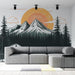 Un salon moderne avec un papier peint illustrant des montagnes enneigées sous un grand soleil orange, créant une atmosphère chaleureuse et apaisante.