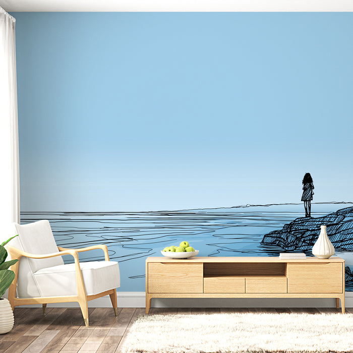 Une pièce lumineuse avec un papier peint illustratif représentant une silhouette contemplative face à un paysage marin minimaliste, évoquant sérénité et réflexion.