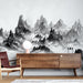 Une pièce moderne avec un papier peint représentant des montagnes en noir et blanc, créant une atmosphère artistique et apaisante.