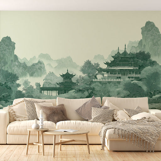 Un salon élégant avec un papier peint représentant un paysage asiatique en nuances de vert, créant une atmosphère sereine et apaisante.