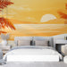 Une chambre moderne avec un papier peint représentant un paysage côtier au coucher de soleil dans des teintes chaudes d'orange et de jaune, évoquant une atmosphère apaisante et tropicale.