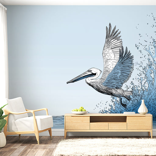 Une pièce lumineuse avec un papier peint illustrant un pélican en plein vol, entouré de vagues stylisées dans des teintes de bleu, créant une ambiance marine et apaisante.