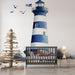 Papier peint chambre enfant avec phare maritime bleu et blanc entouré de rochers et oiseaux.