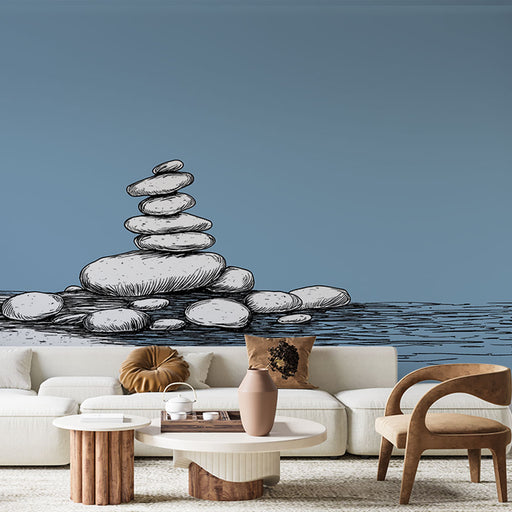 Un salon moderne avec un papier peint représentant des pierres empilées sur un fond bleu apaisant, créant une atmosphère zen et sereine.